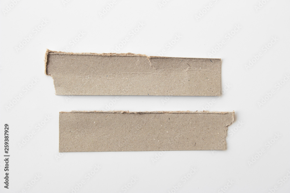 Brown corrugated texture paper torn on white background. rip of cardboard sheet used as a background . Brown corrugated texture paper torn on white background. rip of cardboard sheet used as a background .
