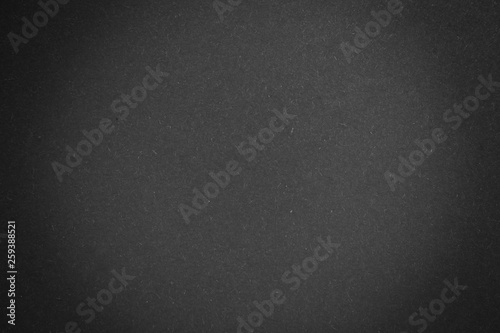 black paper texture or background with spotlight, dark wall backdrop wallpaper, dark tone.
