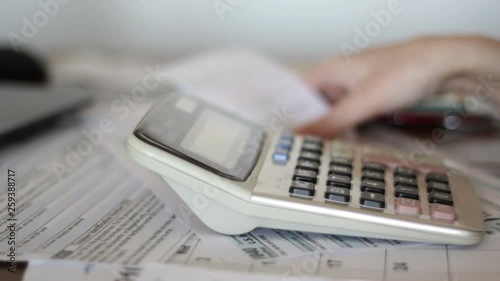 Woman calculate domestic bills at home for tax purposes