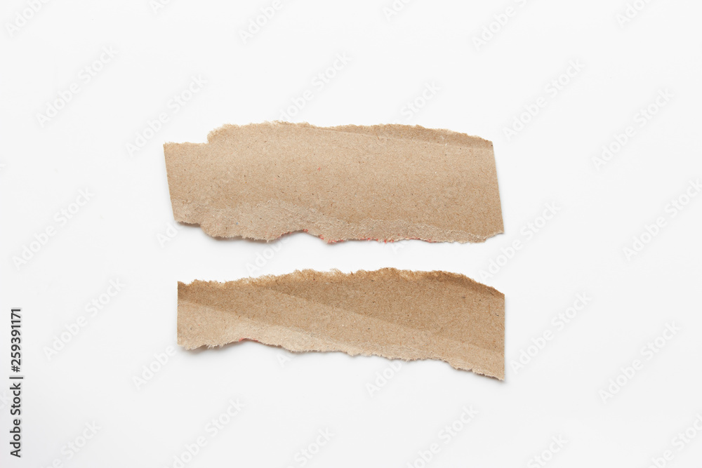 Brown corrugated texture paper torn on white background. rip of cardboard sheet used as a background . Brown corrugated texture paper torn on white background. rip of cardboard sheet used as a background .
