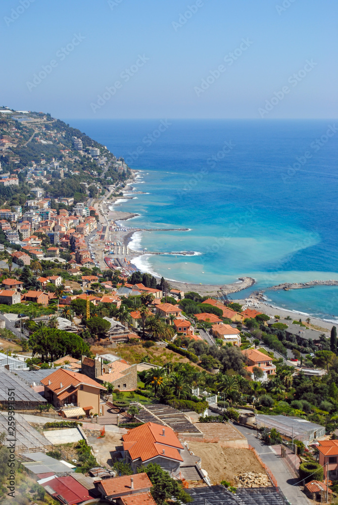traditional typical Italian village with colorful buildings, Ligurian Sea, blue sky background