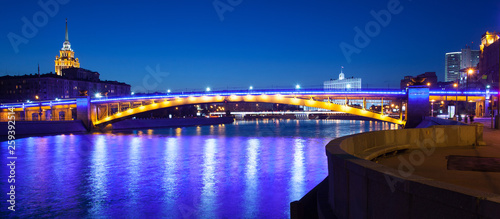 panorama of Moscow city with lighting Smolensky bridge and river at summer evening