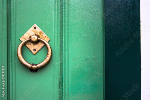 Old wooden doors with an old metal door handle knocker