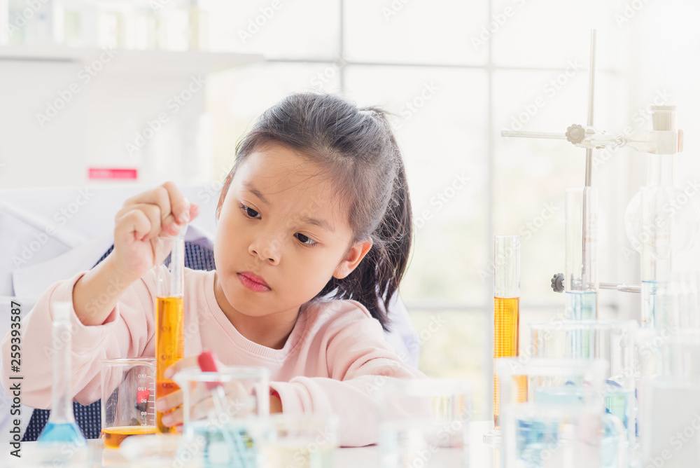 Science and education concept,Girl doing experiments in the laboratory.Little chemist holds scientific experiment ,Science and education concept Science and education concept,Girl doing experiments in the laboratory.Little chemist holds scientific experiment ,Science and education concept