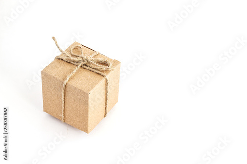 Kraft box isolated on white background. Gift box on white. The concept of stylish gift wrapping.