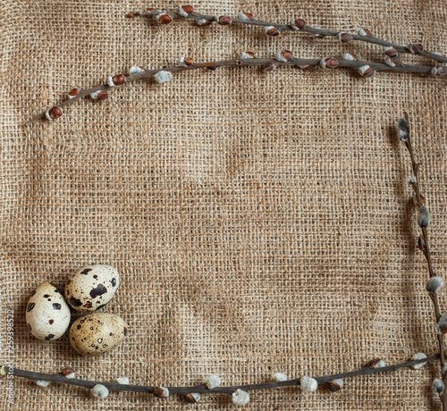 Easter day. A small nest with quail eggs on a sackcloth background, texture of burlap. With free space for text input, logo, etc.