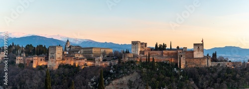 Horizontal panoramic photo of sunset view at the Alhambra palace and fortress in Granada, Spain