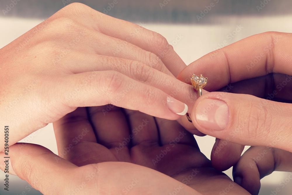Close up Groom Putting the Wedding Ring on bride Close up Groom Putting the Wedding Ring on bride