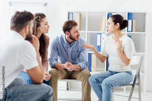 people sitting and having discussion during group therapy meeting © LIGHTFIELD STUDIOS