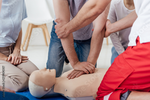 cropped view of group of people during first aid training with dummy © LIGHTFIELD STUDIOS