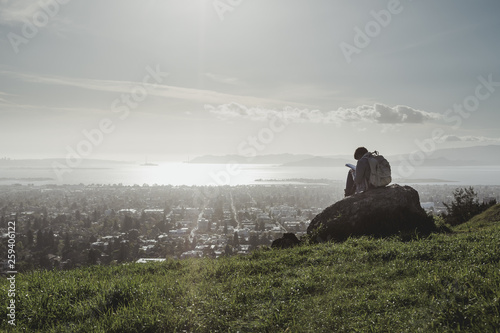 Creative Artist or Writer Drawing or Writing on a Hill with View of San Francisco City  photo