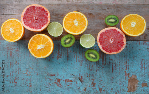 Pattern of citrus (orange, grapefruit, lemon, lime) fruit and kiwi on the wooden background © k8most