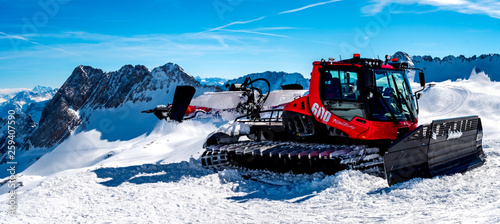 Obraz na płótnie Snow Mobile on top of the rock with blue sky Background in high resolution