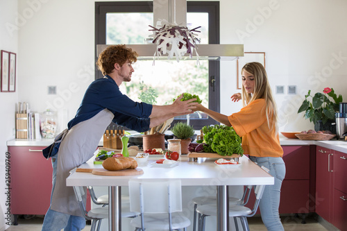 Woman helping man in kitchen photo