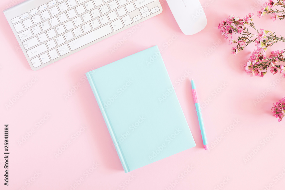 Office pink table, notepad, keyboard, flowers, notebook, stationery on pink background. Business minimal concept for women. Flat lay, top view, copy space Office pink table, notepad, keyboard, flowers, notebook, stationery on pink background. Business minimal concept for women. Flat lay, top view, copy space