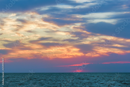 Fototapeta Naklejka Na Ścianę i Meble -  Scenic bright sunset over the blue sea