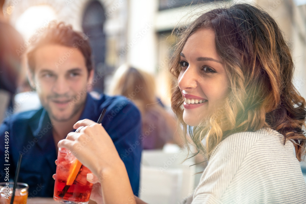 Smiling young couple sitting at outdoor cafe Smiling young couple sitting at outdoor cafe