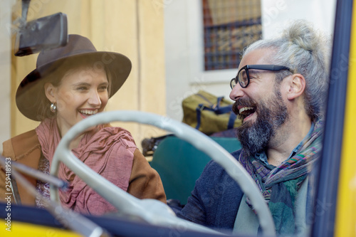 Smiling couple sitting in car