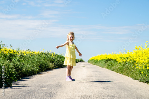 little child walking in rural path in beautiful summer nature