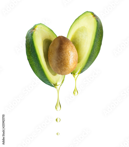 Fotografia Drops of oil dripping from avocado, isolated on white background