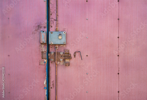 Locked doors. Old door latch. The locking mechanism on the old door.