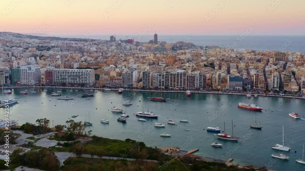Aerial view of Sliema city and Portomaso tower on sunset sky. Malta Aerial view of Sliema city and Portomaso tower on sunset sky. Malta