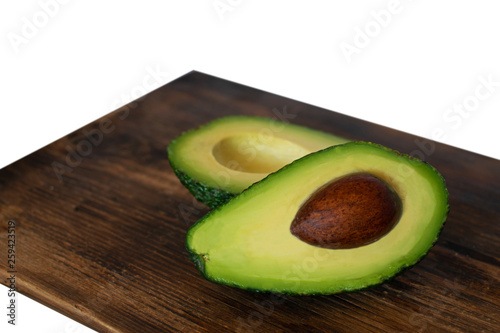Avocado on wooden board isolated on white background.