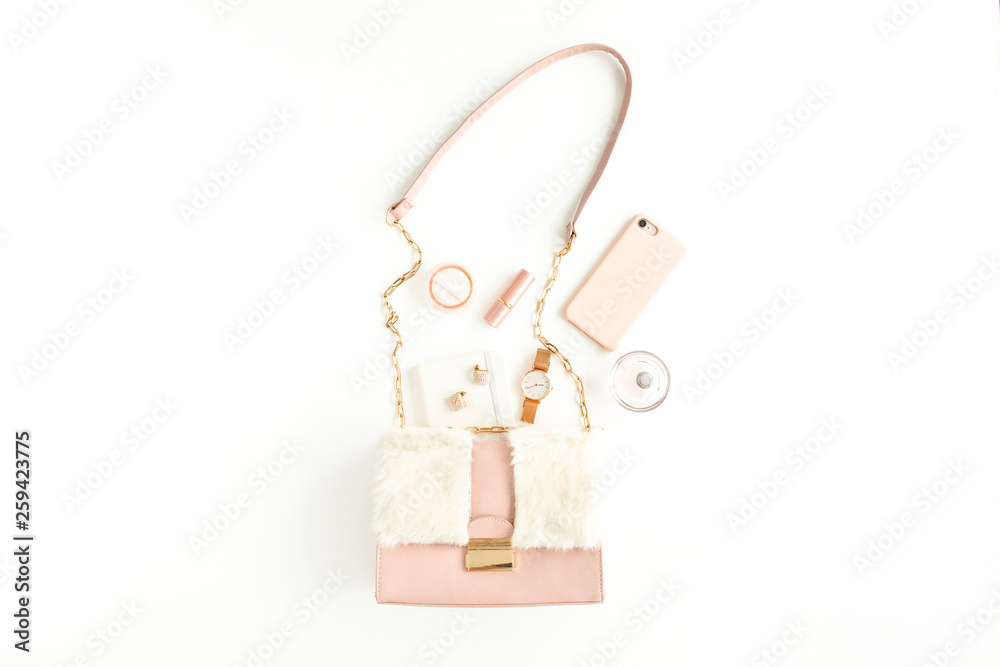 Women's pink bag with fashion trendy accessories: watch, perfume, phone, lipstick, earrings on white background. Flat lay, top view Women's pink bag with fashion trendy accessories: watch, perfume, phone, lipstick, earrings on white background. Flat lay, top view