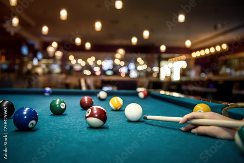 Selective focus at billiard ball on blue table photo
