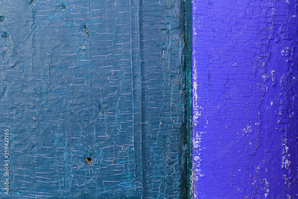 Obraz premium Old wooden background with remains of pieces of scraps of old paint on wood. Texture of an old tree, vintage wood background peeling paint. old blue board with cracked paint