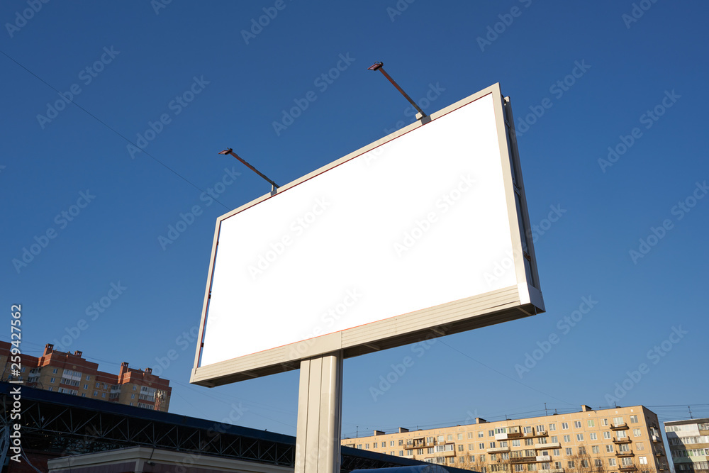 3x6 big billboard standing in the city against the sky during the daytime, with a white advertising space mockup 3x6 big billboard standing in the city against the sky during the daytime, with a white advertising space mockup