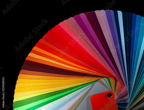 Color fan deck with samples of various paint isolated on a black background