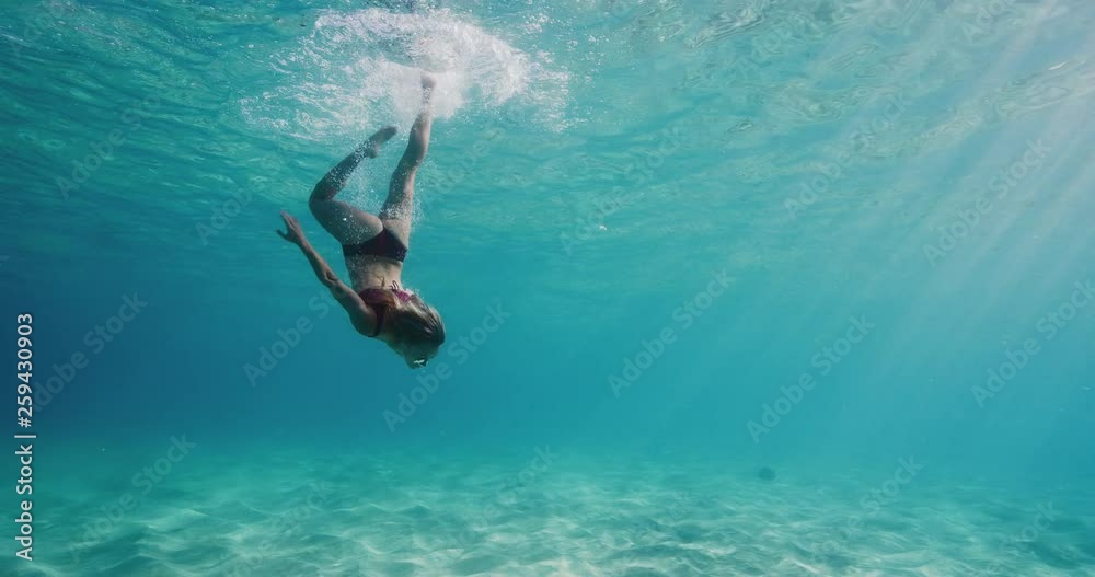 Beautiful woman swimming in underwater paradise