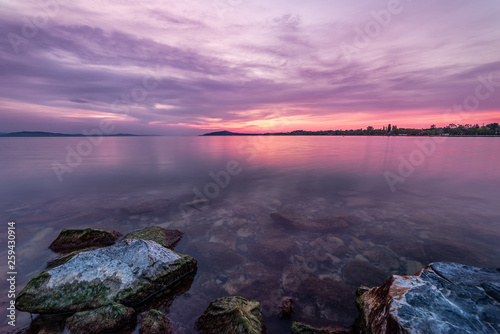 Lake Balaton vibrant colourful sunrise at the beach in Balatonfenyves , Hungary photo