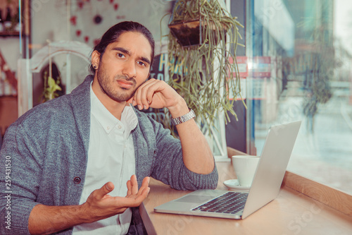 Fotografie Man looking frustrated hand gesture in front of the computer