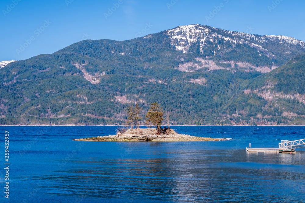 Fantastic view over ocean, snow mountain and rocks at Sechelt inlet in Vancouver, Canada.
