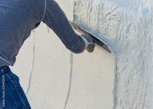 Obraz na płótnie Worker Smoothing Wet Pool Plaster With Trowel