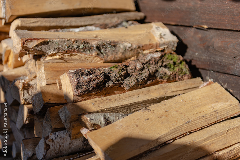 Woodpile. Firewood stacked in a woodpile. Birch wood at close range. Woodpile. Firewood stacked in a woodpile. Birch wood at close range.