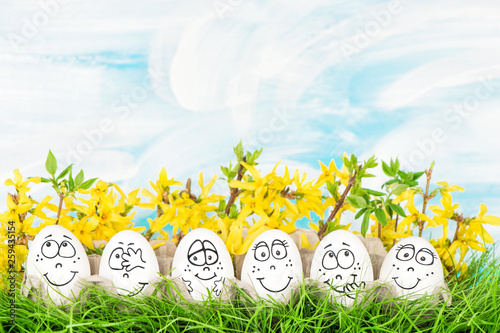 Fototapeta Easter eggs yellow flowers decoration green grass