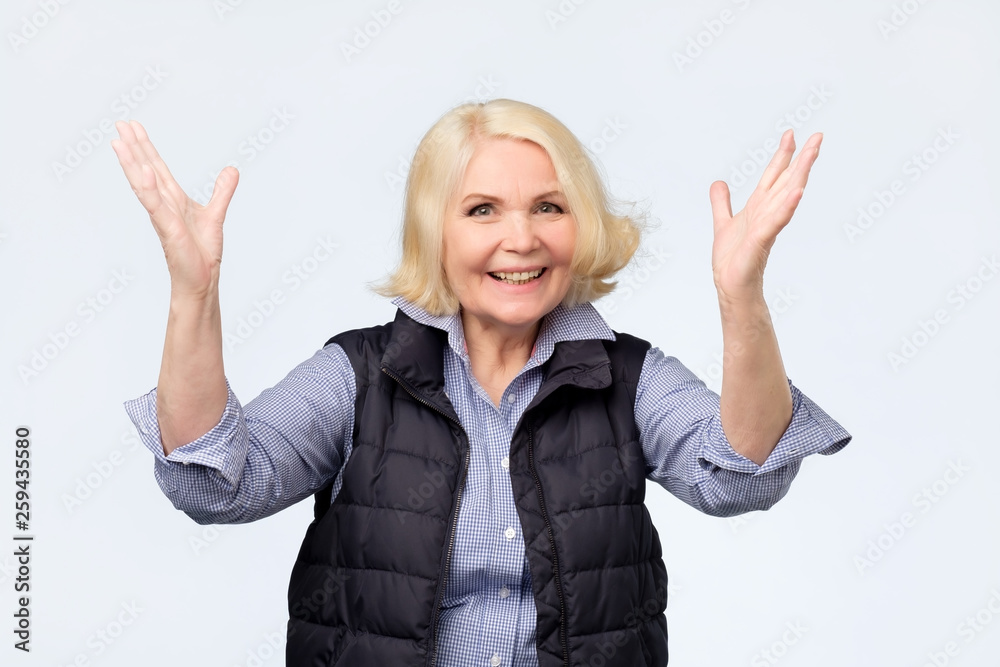Senior woman raising hands up for positive feeling Senior woman raising hands up for positive feeling
