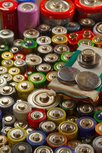 Dozens of types, sizes, colors of used batteries and accumulators. Recycling.