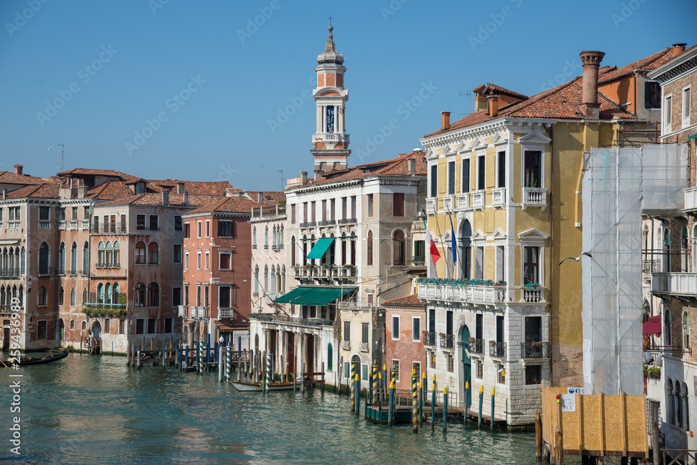 Gondola passing by multicolored buildings