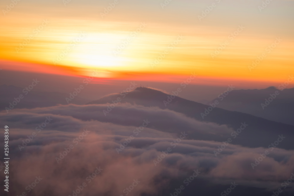 Landscape view point looking for foggy mist cover forest mountain and beautiful sunrise colorful sky Landscape view point looking for foggy mist cover forest mountain and beautiful sunrise colorful sky