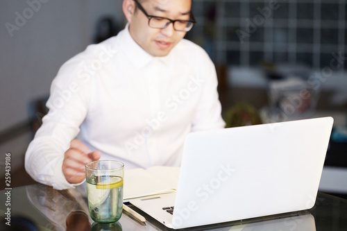 Young Asian businessman is working on laptop in office