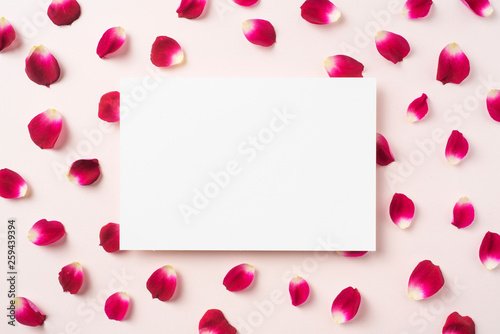 top view of red rose petal with white card © voyata