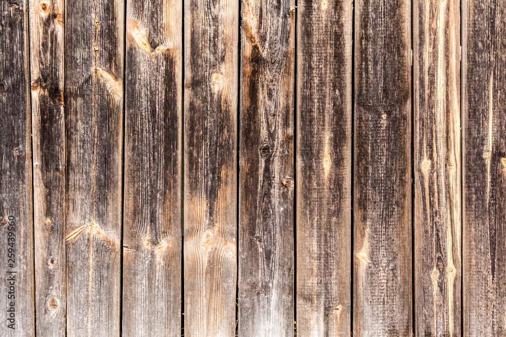 Fototapeta premium old vertical weathered boards, texture of dark antique wood panels, decor abstraction background
