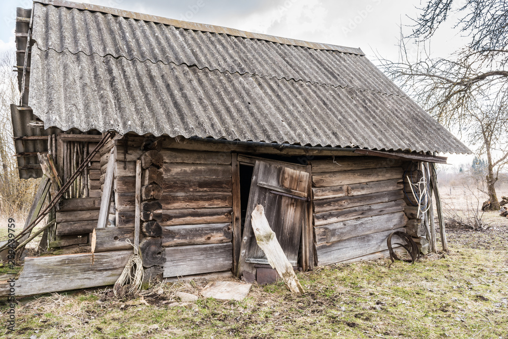 old damaged abandoned wooden building, broken country house of wooden logs, historical slavic architecture abstraction background