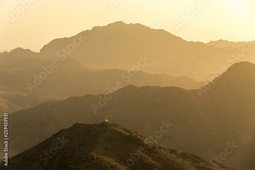 View of the sunrise on the bare mountain from the top of the mountain