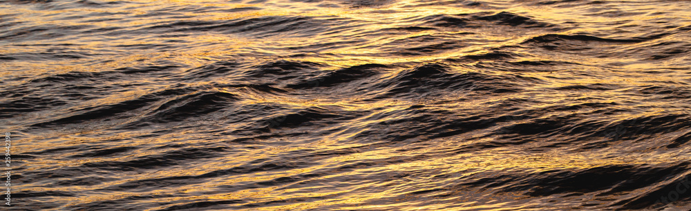 red and golden light of the sunrise in the sea water. Summer and beach concept. red and golden light of the sunrise in the sea water. Summer and beach concept.