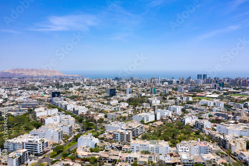 Lima, Peru - March 12 2019: Aerial view of Miraflores district including La Aurora parks. Clear and bright day, travel and destinations concept. Drone aerial shot of Lima's cityscape.
